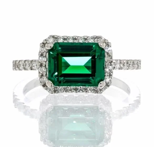 Emerald Gemstone Rings Set in Platinum with Filigree Work for a Vintage - Inspired LookEmerald Cubic Zirconia Halo Engagement Ring In Sterling Silver