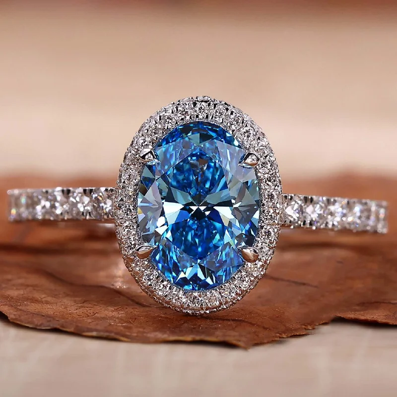 Vintage - Inspired Engagement Rings with Filigree Work and Emerald - Cut Center StoneOval Halo Engagement Ring with Blue Lab Grown Diamond IGI Certified