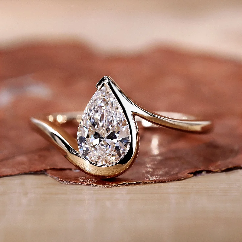 Art Deco Engagement Rings with Geometric Patterns and Baguette - Cut Diamond AccentsPear Shaped Engagement Ring Timeless and Unique Design